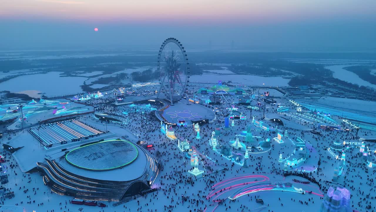 Slow aerial shot of the Harbin Ice Festival at Blue Hour in Harbin, China.
