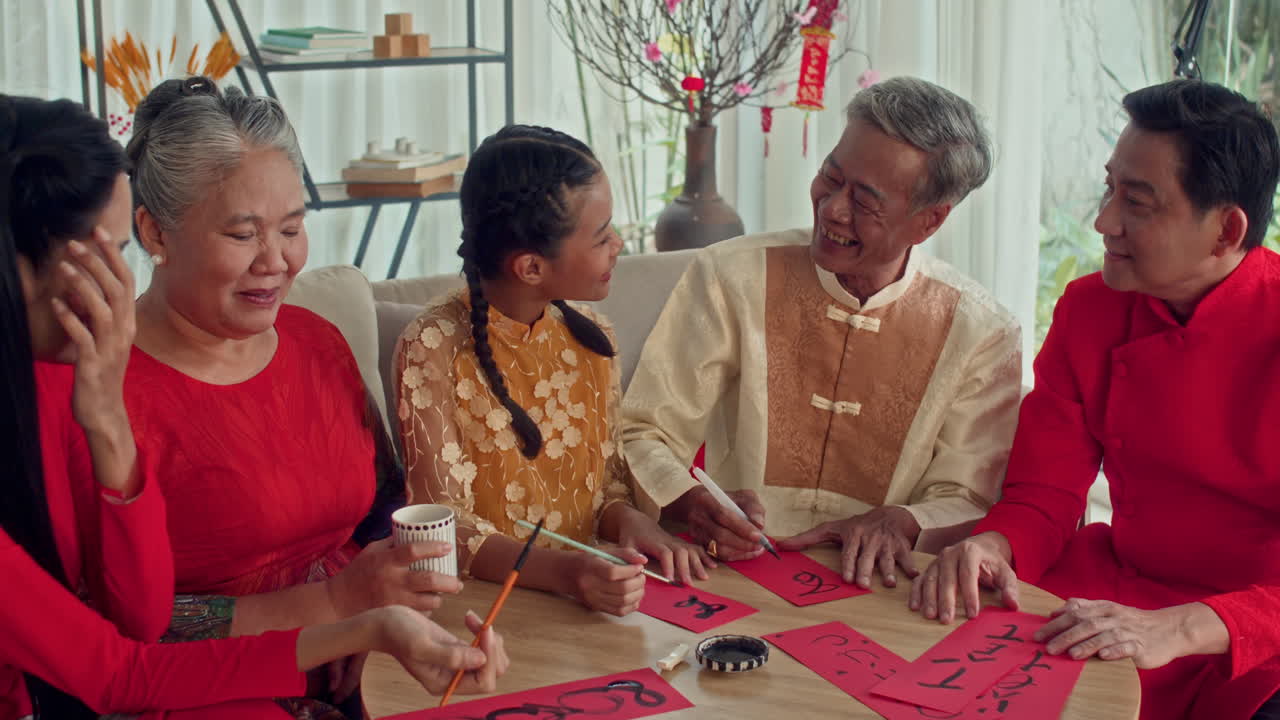 Parents Teaching Teenage Girl Traditional Calligraphy at Tet