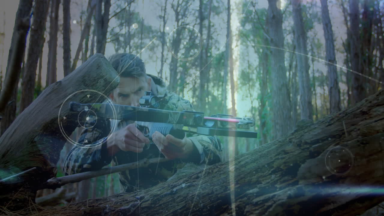 Camouflaged man crouching behind log in pine forest, with animated technology HUD guiding shot