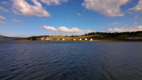 Drone-shot-flying-over-the-water-towards-and-then-over-the-Estancia-Harberton-in-Tierra-del-Fuego,-Argentina