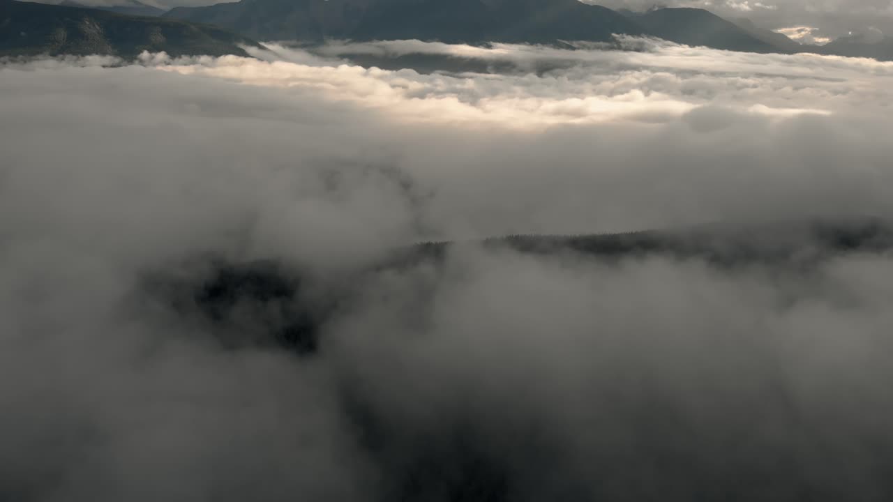 Dark clouds over the mountain landscape of Alberta - aerial