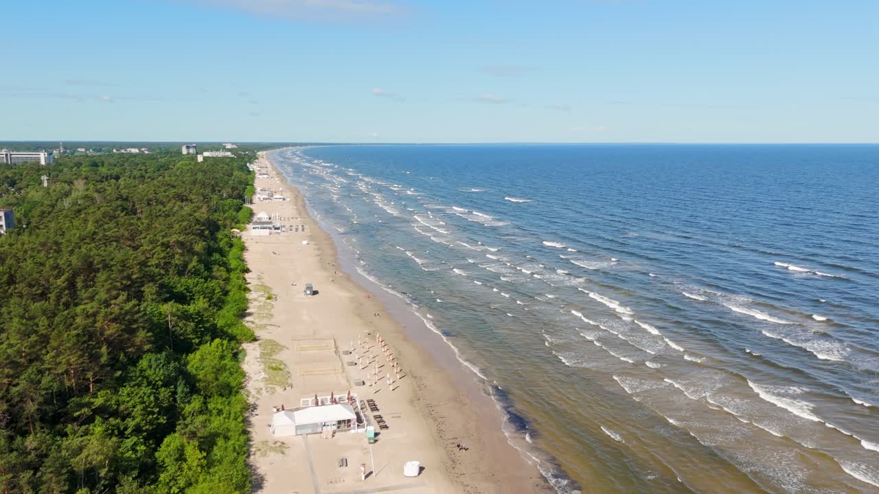 Drone view of Jurmala Latvia sandy beach with waves and Baltic Sea forest coast