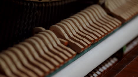 Piano-hammers-hitting-the-strings-on-a-piano-in-slow-motion