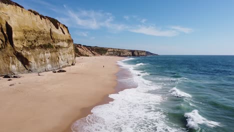 praia das bicas beach at castelo, alentejo, west coast portugal - aerial drone view of the waves, sandy beach and rocky coastline