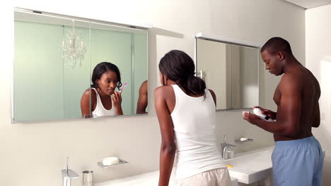 couple brushing their teeth together