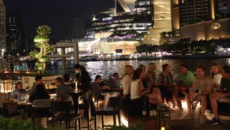 group of friends enjoying evening on rooftop bar