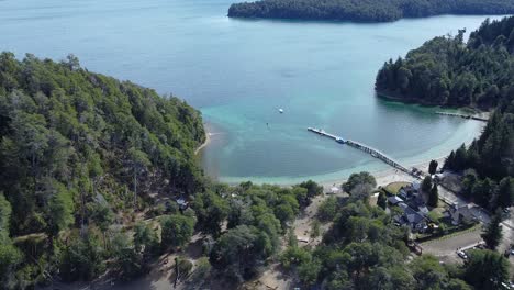 Lake,-forest-and-beaches-of-crystal-clear-water-with-the-snowy-peaks-of-the-andes-at-the-background,-in-Ithsmus-in-lake-Nahuel-Huapi