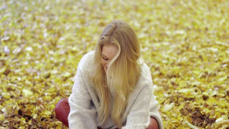 Woman-rejoicing-at-falling-leaves