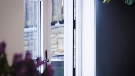 woman entering home wearing winter coat