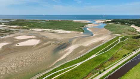 Lake-and-river-flowing-through-green-polder-landscape-at-Netherlands-and-Belgium-border,-Het-Zwin-nature-reserve