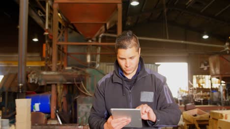 worker using digital tablet in foundry workshop 4k