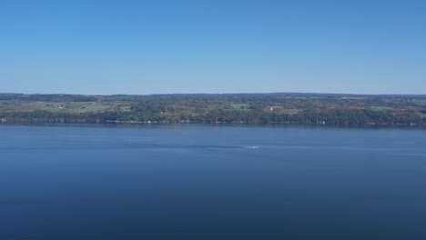 wide aerial view of seneca lake in the finger lakes ny looking eastward with a boat in the distance