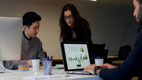 Business-colleagues-discussing-over-document-in-office-4k