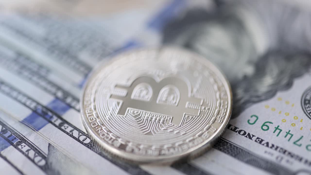 Bitcoin coin on US dollar bills