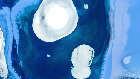 pullback rising from blue shiny ink with white circle in abstract ocean liquid pattern