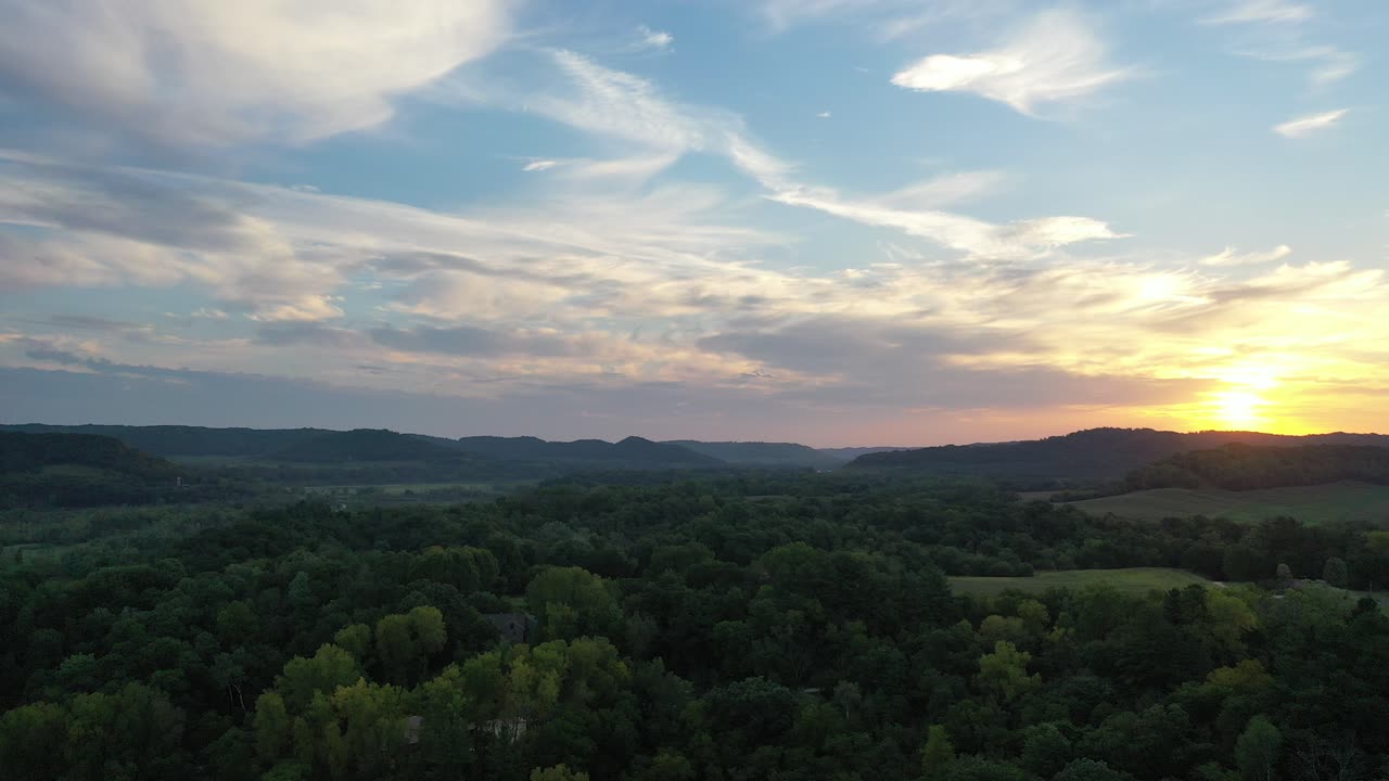Sunset over a Valley with Forest and Hills