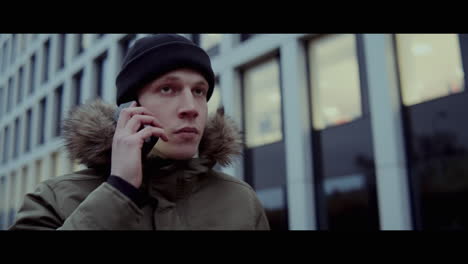 young man talking on phone in the city
