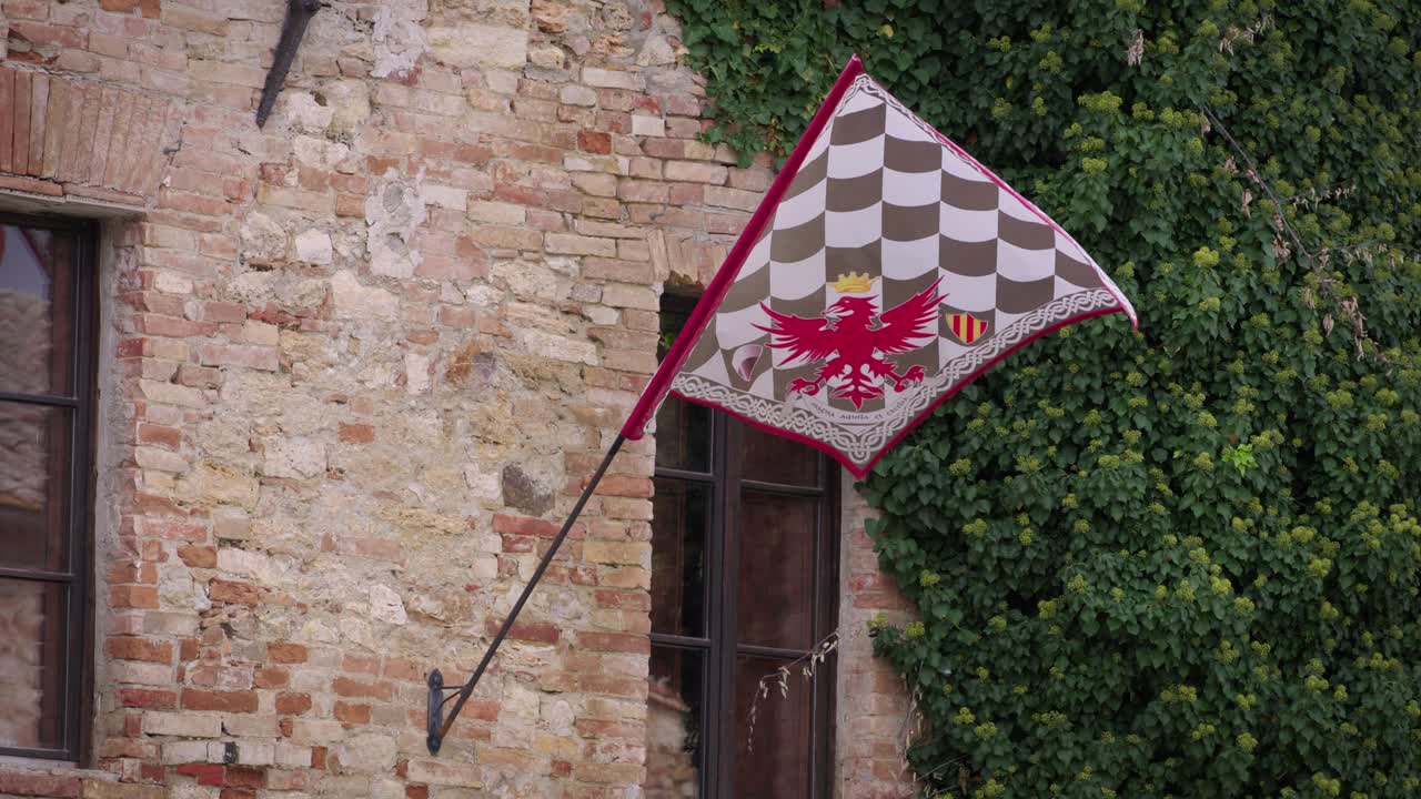 Medieval Flag with Eagle Emblem on Brick Wall
