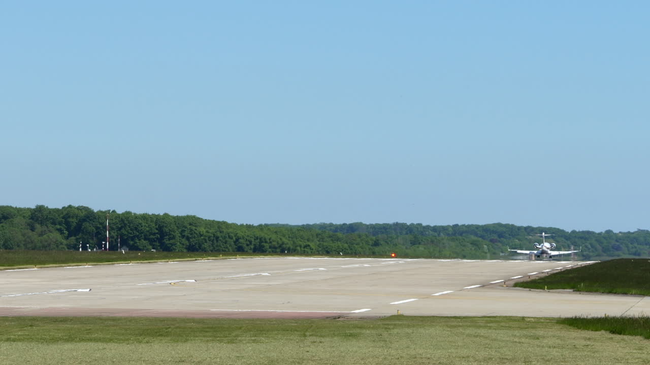 Private Jet Plane Lands On Runway Of Geneva Airport In Switzerland. - wide shot