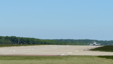 private jet plane lands on runway of geneva airport in switzerland. - wide shot