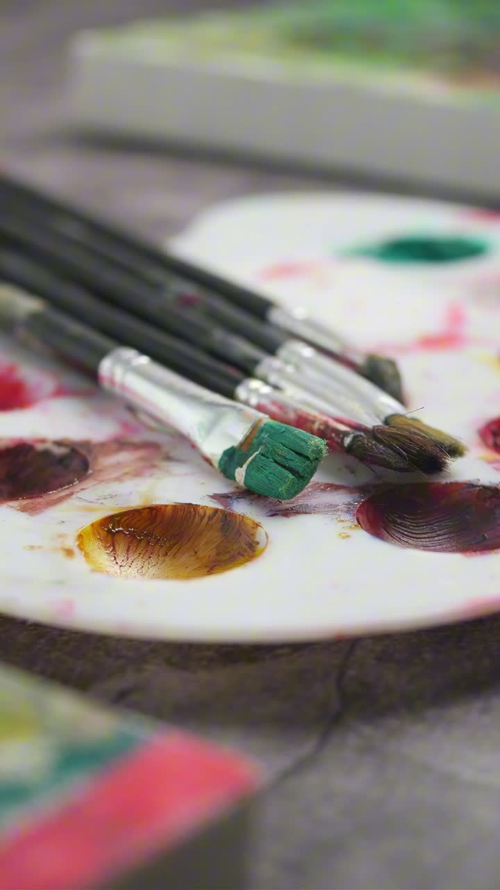 Artist's Paint Palette with Brushes and Vibrant Colors