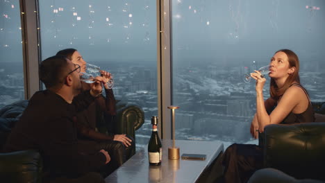 friends celebrating with champagne in a high-rise restaurant