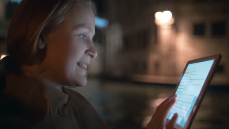 Woman-chatting-on-pad-during-boating-in-Venice-at-night