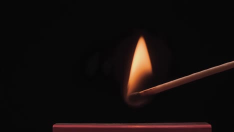 burning match on a black background