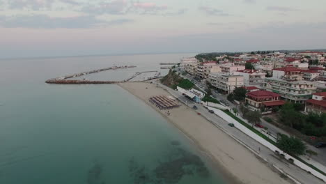 Flying-over-resort-town-with-quay-Nea-Kallikratia-Greece