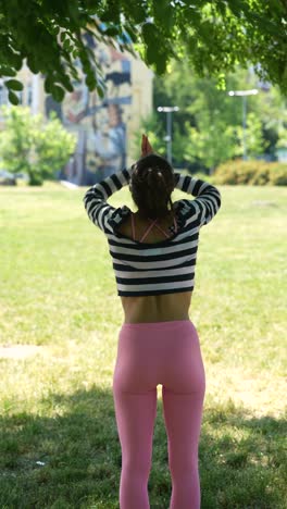 woman practicing yoga in a park