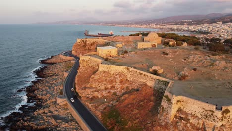 drone aerial flight in front of the venetian fortezza citadel in the city rethymno - drone flight at sunset in greece crete