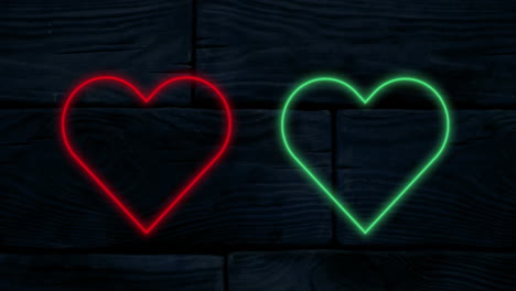 animation of red and green neon hearts flashing on a black background