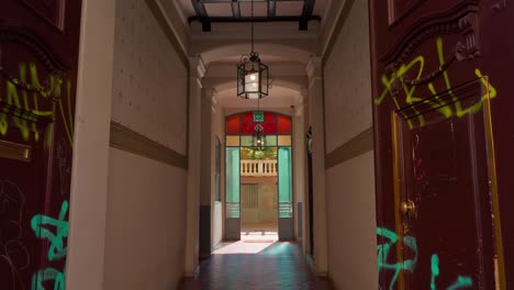 wide shot of an internal courtyard in a milanese-style building featuring elegant architecture and vibrant stained glass windows in milan milano italy