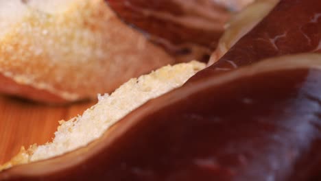 Macro-shot-of-dried-or-smoked-beef-meat-on-slices-onbread,-macro-shot-close-up-view-in-4k