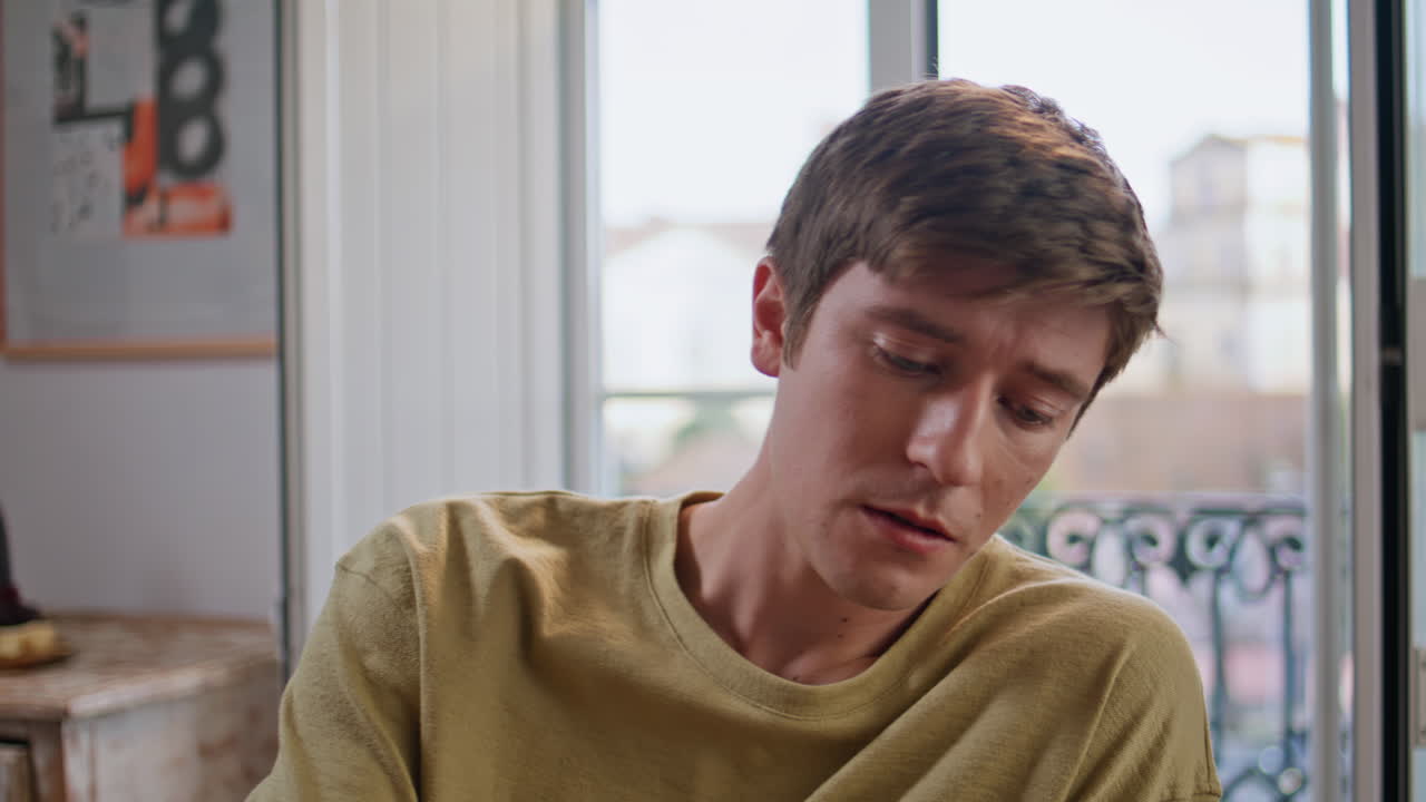 Relaxed guy drinking wine resting at weekend home party closeup. Teen talking