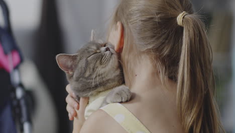 child hugging a cat