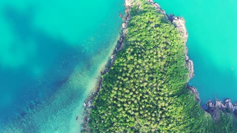 Paradise-tropical-island-with-green-vegetation-and-beautiful-coastline-of-cape-surrounded-by-turquoise-calm-lagoon-in-Thailand