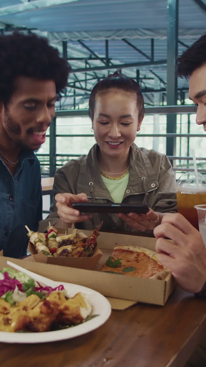 Friends Taking Photo of Ordered Pizza and Skewers on Phone at Local Food Market