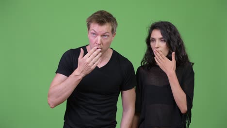 young couple looking shocked together