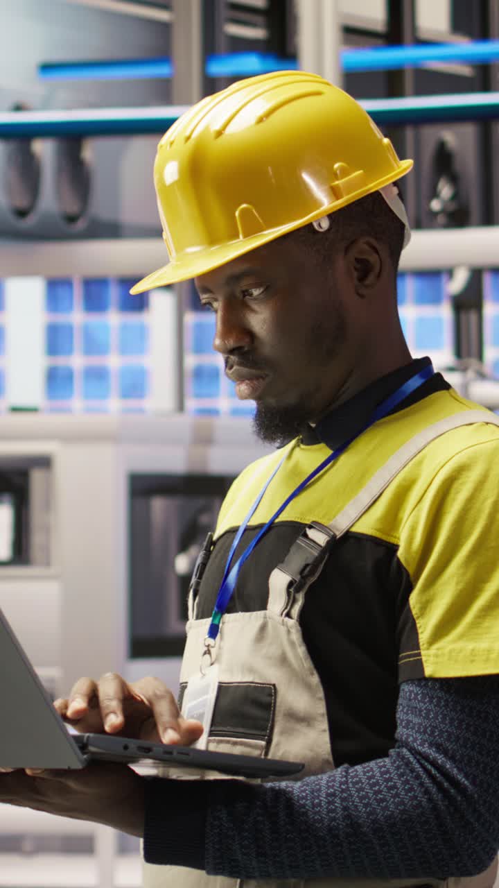 Vertical video Industry 4.0 plant engineer following maintenance procedures to mend bugs