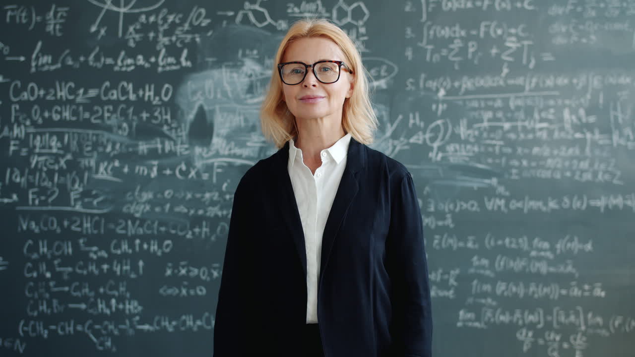 Teacher in front of a chalkboard full of equations