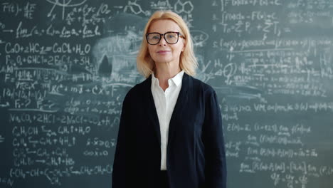 teacher in front of a chalkboard full of equations