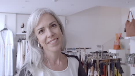 Happy-Caucasian-fair-haired-woman-posing-in-clothes-shop