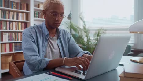 african american business man working on laptop with electronic documents