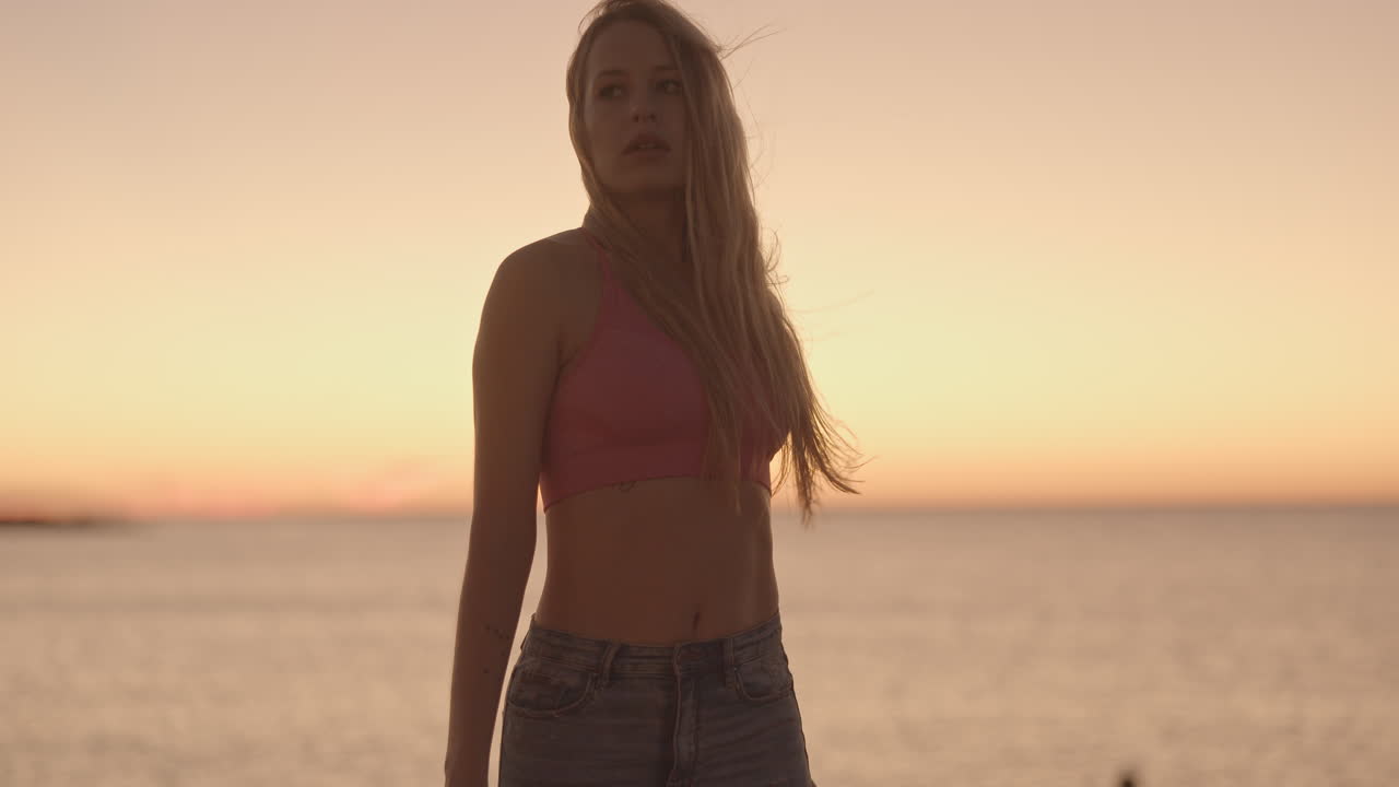 Woman at sunrise by the sea