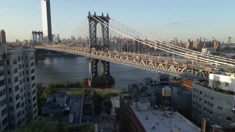 pushing drone shot of the brooklyn bridge located in brooklyn new york during sunset, golden hour