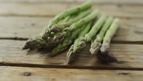 video of fresh asparagus stalks on wooden background