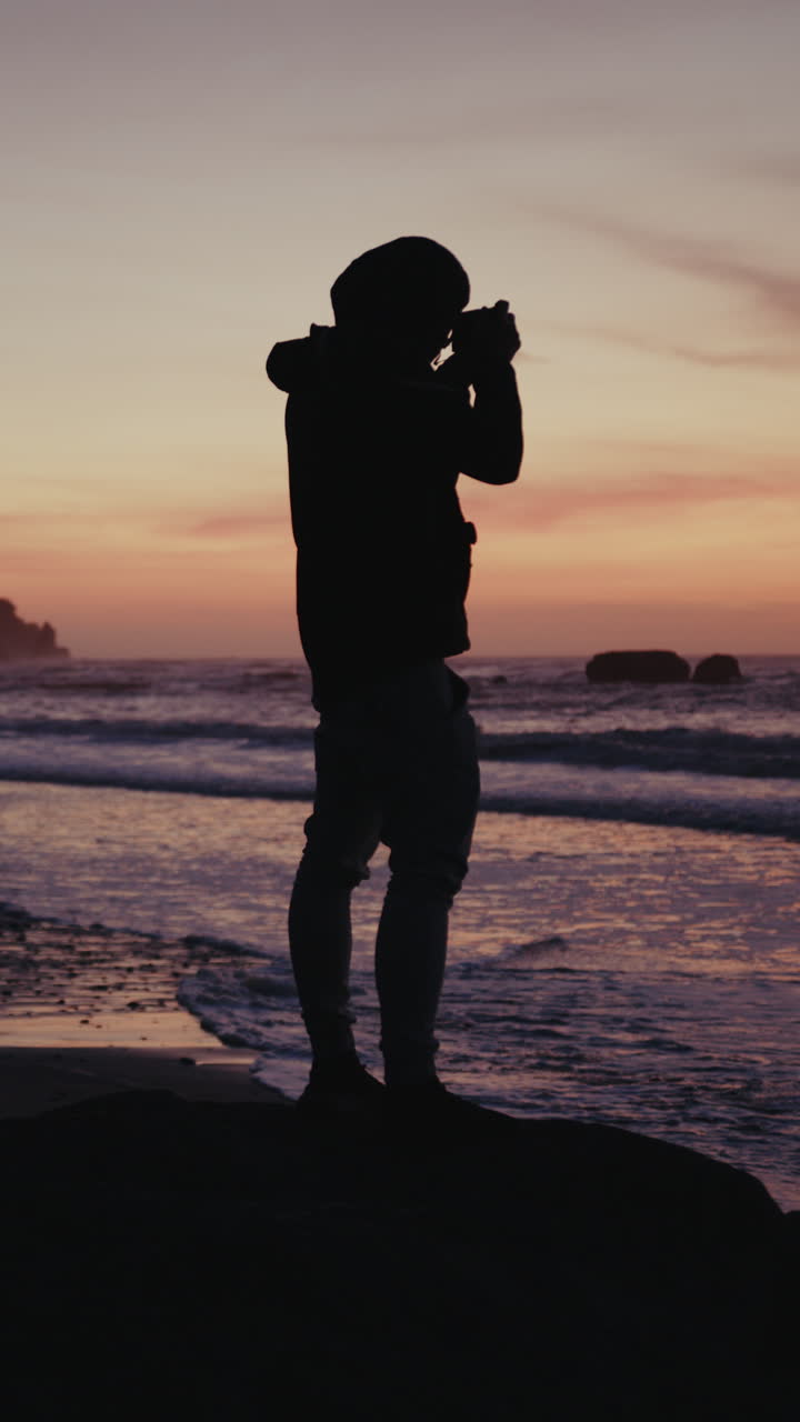 Silhouette of a Photographer at Sunset on a Beach