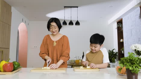 mom and boy cutting bananas.