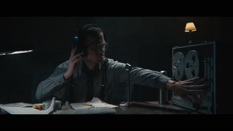 an intelligence officer listens to the wiretap recordings